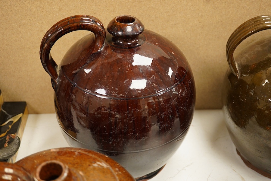 A group of stoneware glazed flagons and jugs, largest 29cm high. Condition - some chips